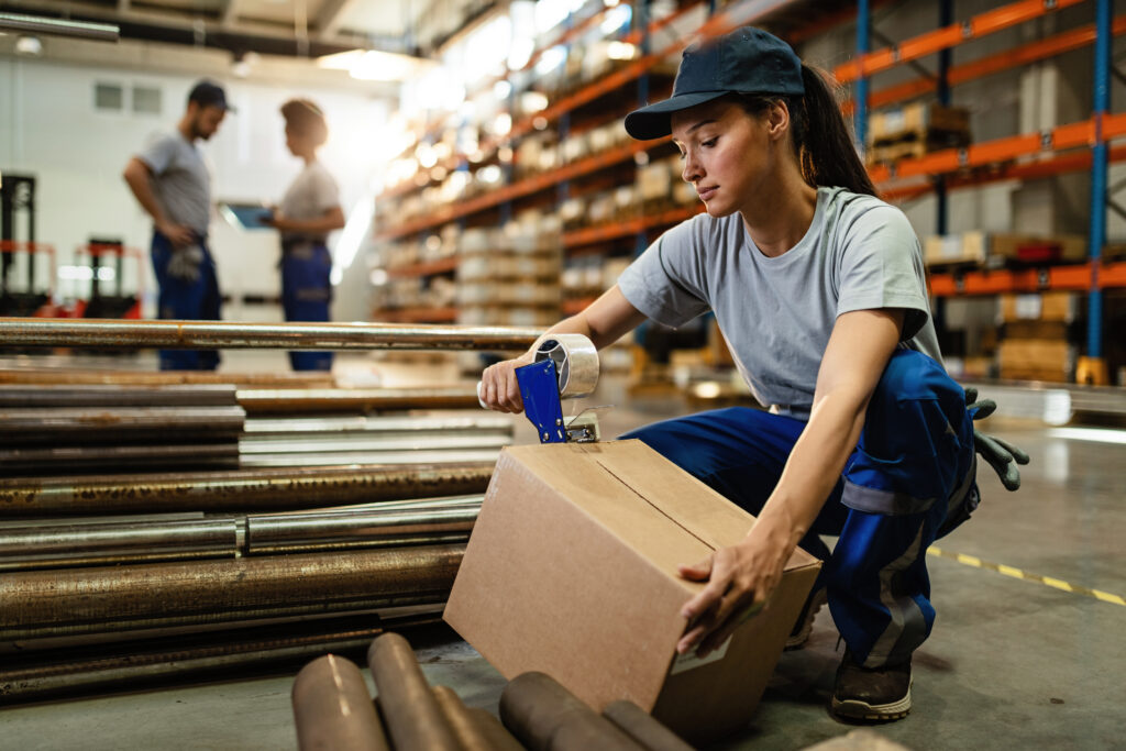 female warehouse worker taping cardboard box with tape dispenser before shipment 3 - KHILJEE PACKAGING